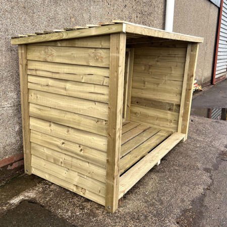 Grampian Logs - Giant Log Store from an angle showing the open front, slatted timber base and interior divider, with feather edge board sides and roof